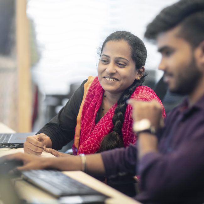 Male and female colleagues planning at office desk