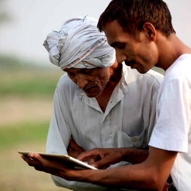 Agronomist consulting with farmer outdoor in the field
