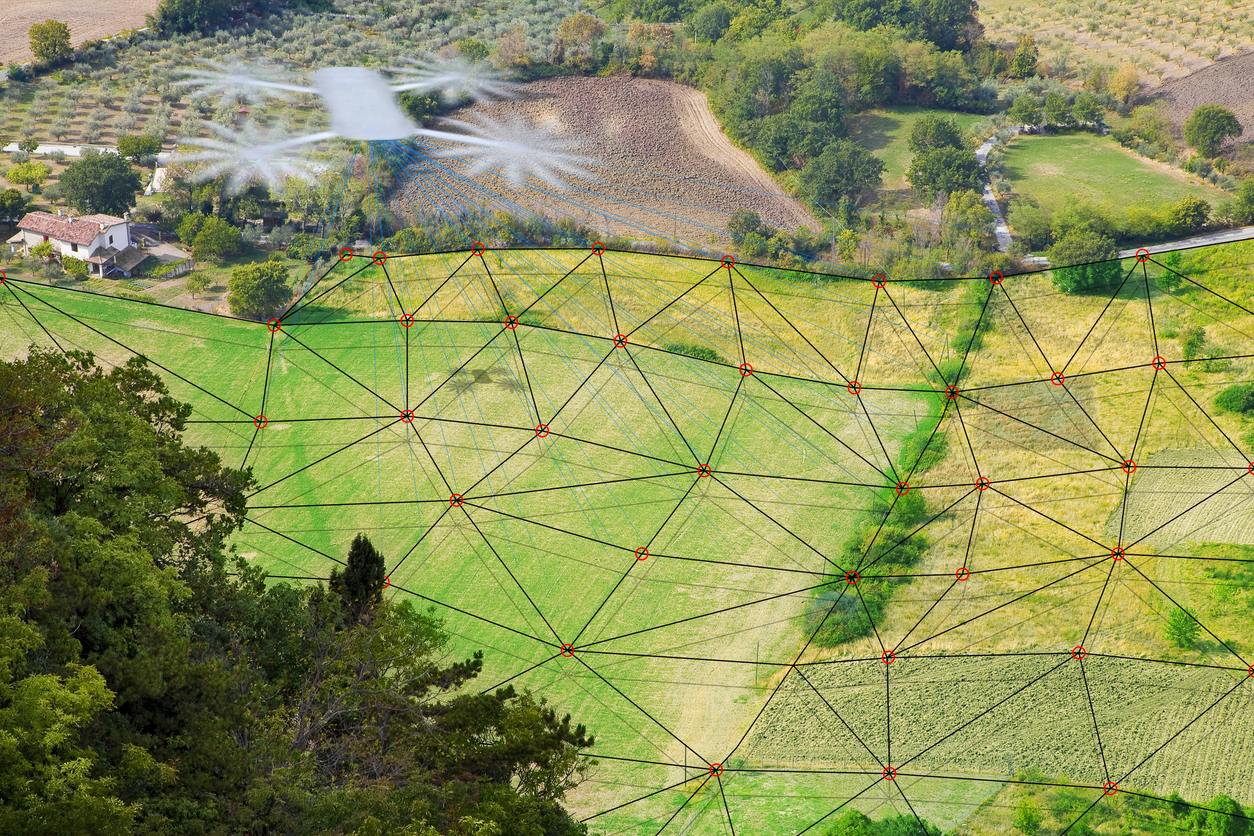 DRONE SURVEYING A FLAT AGRICULTURAL FIELD WITH DIGITAL LASER GRID FOR TOPOGRAPHIC MAPPING and precision agriculture applications